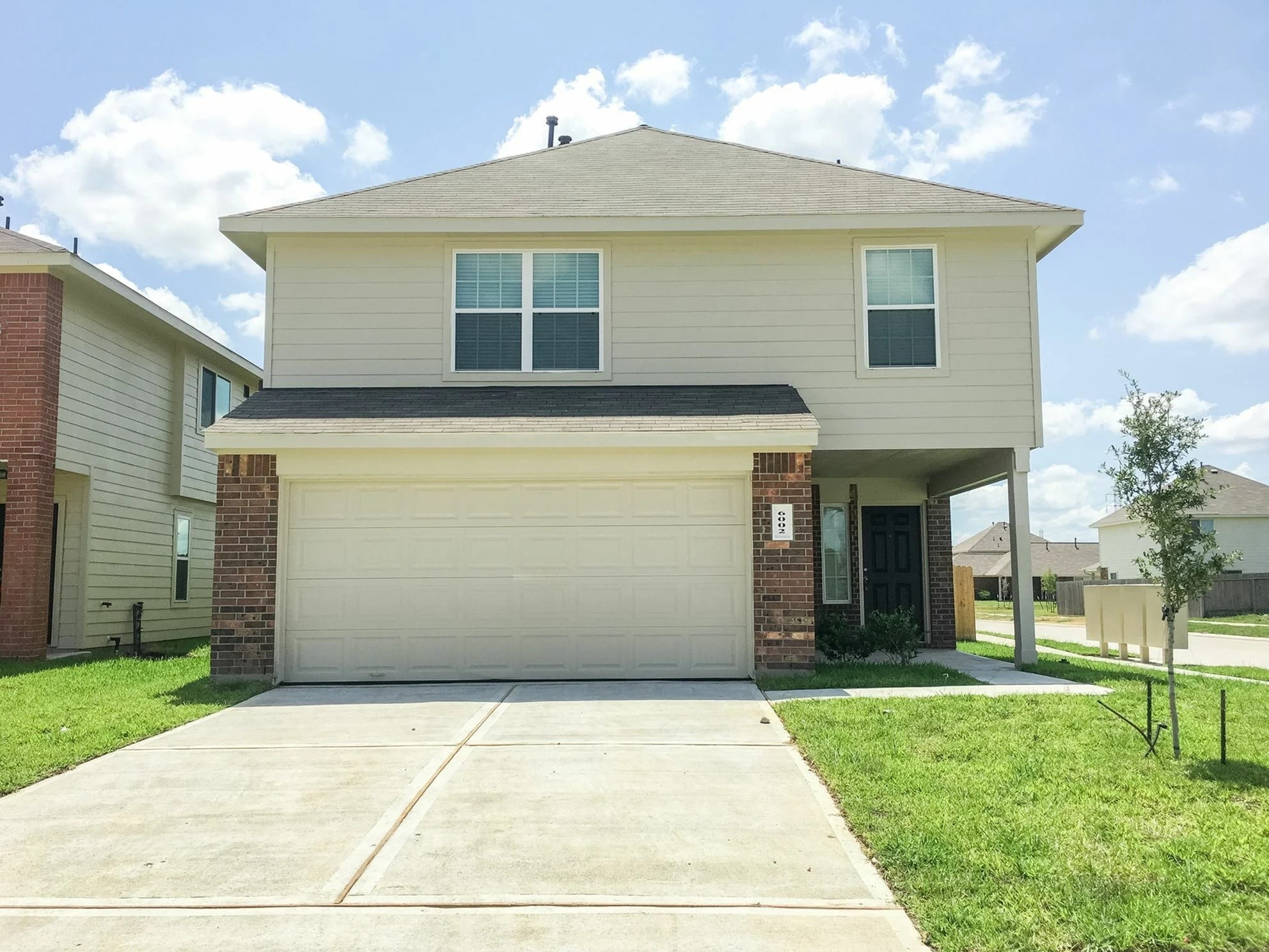 6002 Peaceful Ridge Drive Houston, TX 77048 - Photo 1 of 12 a front view of a house with a yard and garage