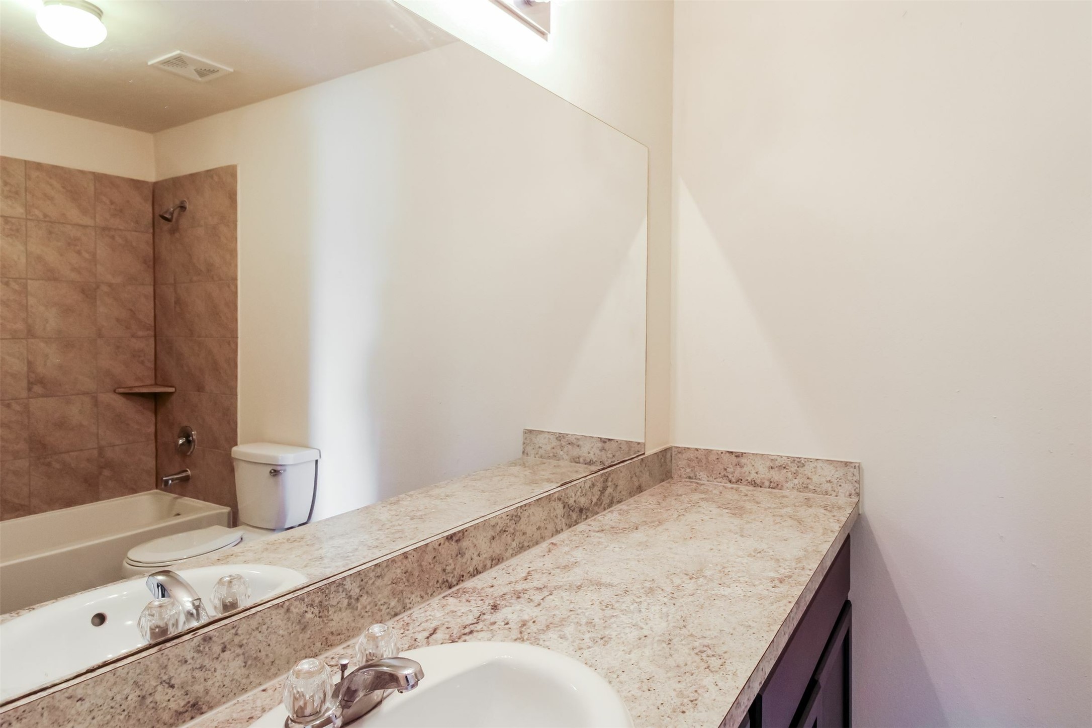 6002 Peaceful Ridge Drive Houston, TX 77048 - Photo 9 of 12 a bathroom with a granite countertop sink and a mirror
