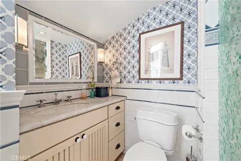 a bathroom with a toilet a sink and a mirror