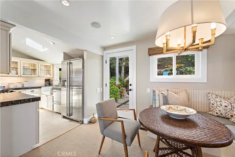 a view of a dining room with furniture a chandelier and wooden floor