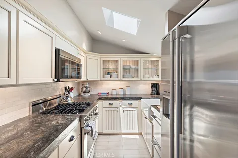 a kitchen with stainless steel appliances granite countertop a stove and a sink