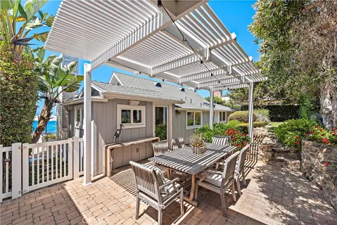 a view of a patio with table and chairs and potted plants