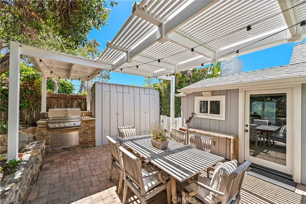 a view of a patio with a table and chairs next to a yard