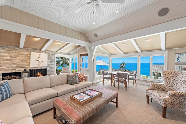 a living room with furniture a fireplace and a large window