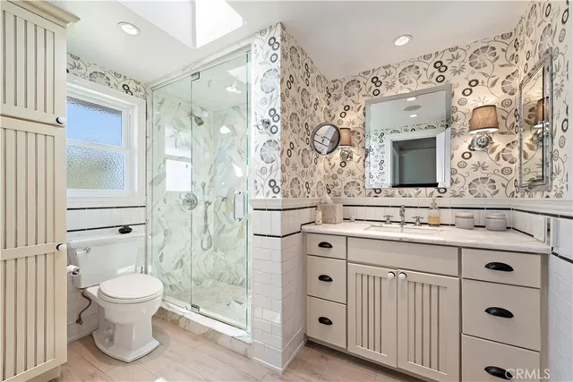 a bathroom with a sink a toilet and shower