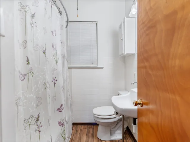 a bathroom with a sink a mirror and a toilet