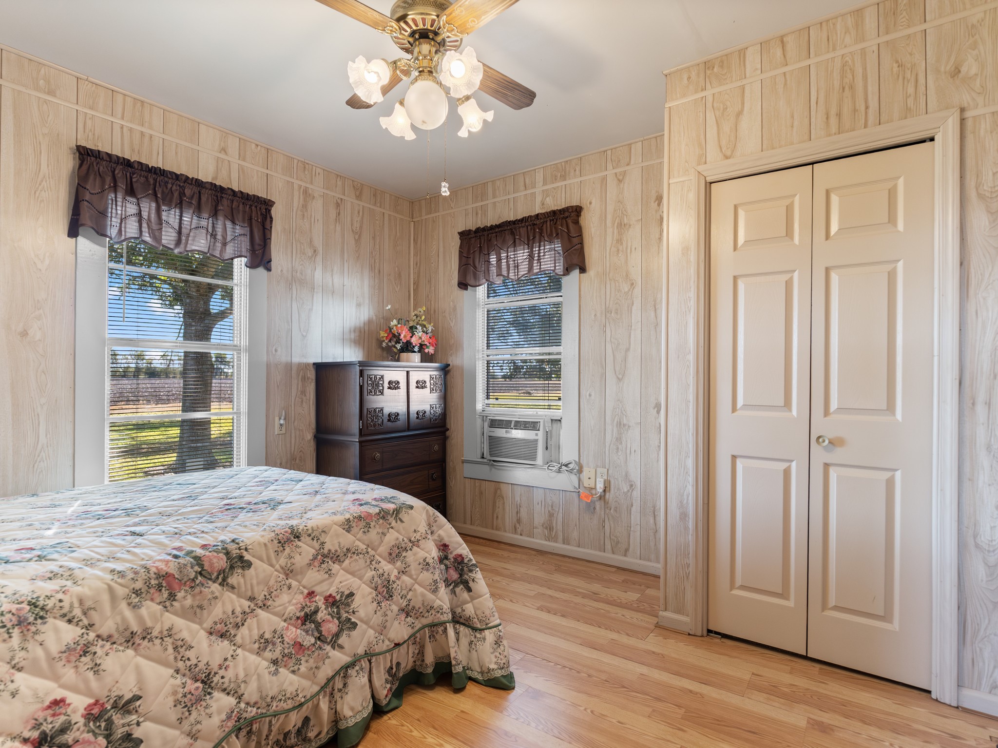 14309 Vrlla Road Guy, TX 77444 - Photo 35 of 41 a bedroom with a large bed and a chandelier