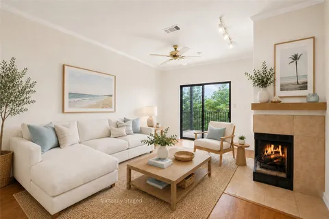 a living room with furniture and a fireplace