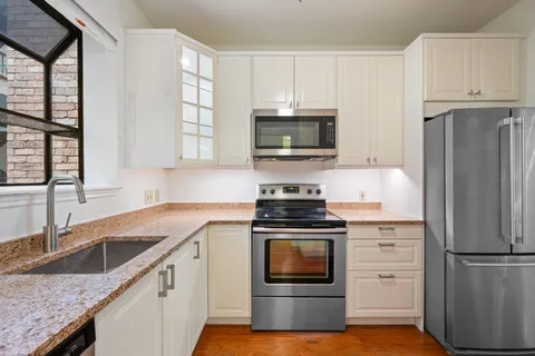 a kitchen with stainless steel appliances a sink dishwasher stove and microwave