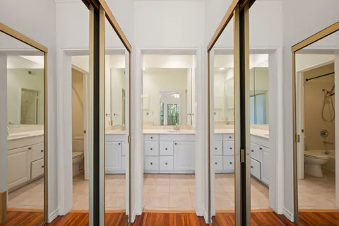 a bathroom with a sink vanity granite toilet and shower