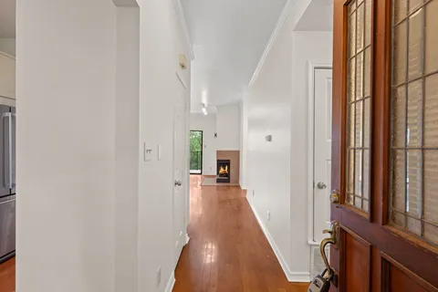 a view of an empty room with a fireplace and a window