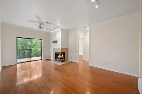 a view of an empty room with a fireplace and a window