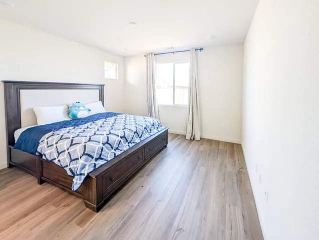 a bedroom with a bed and a window