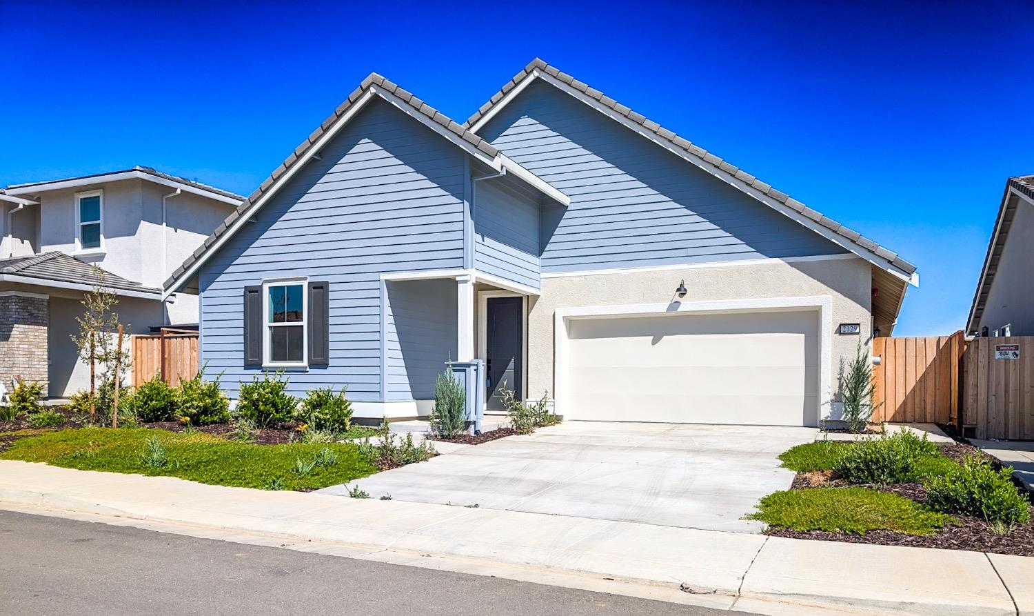 2129 Stagecoach Road Patterson, CA 95363 - Photo 2 of 23 a front view of a house with a garden