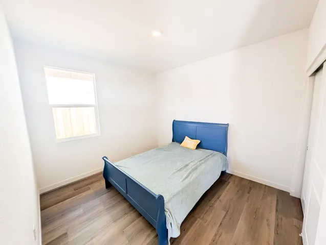 a bedroom with a bed and window