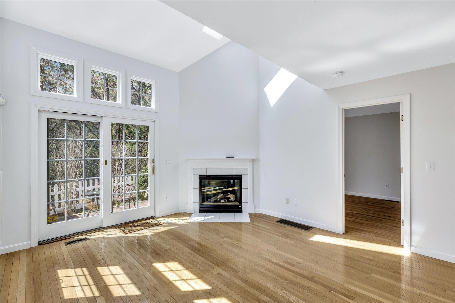 9 Red Cedar Road, Unit 9 Mashpee, MA 02649 - Photo 3 of 29 an empty room with wooden floor cabinet and windows