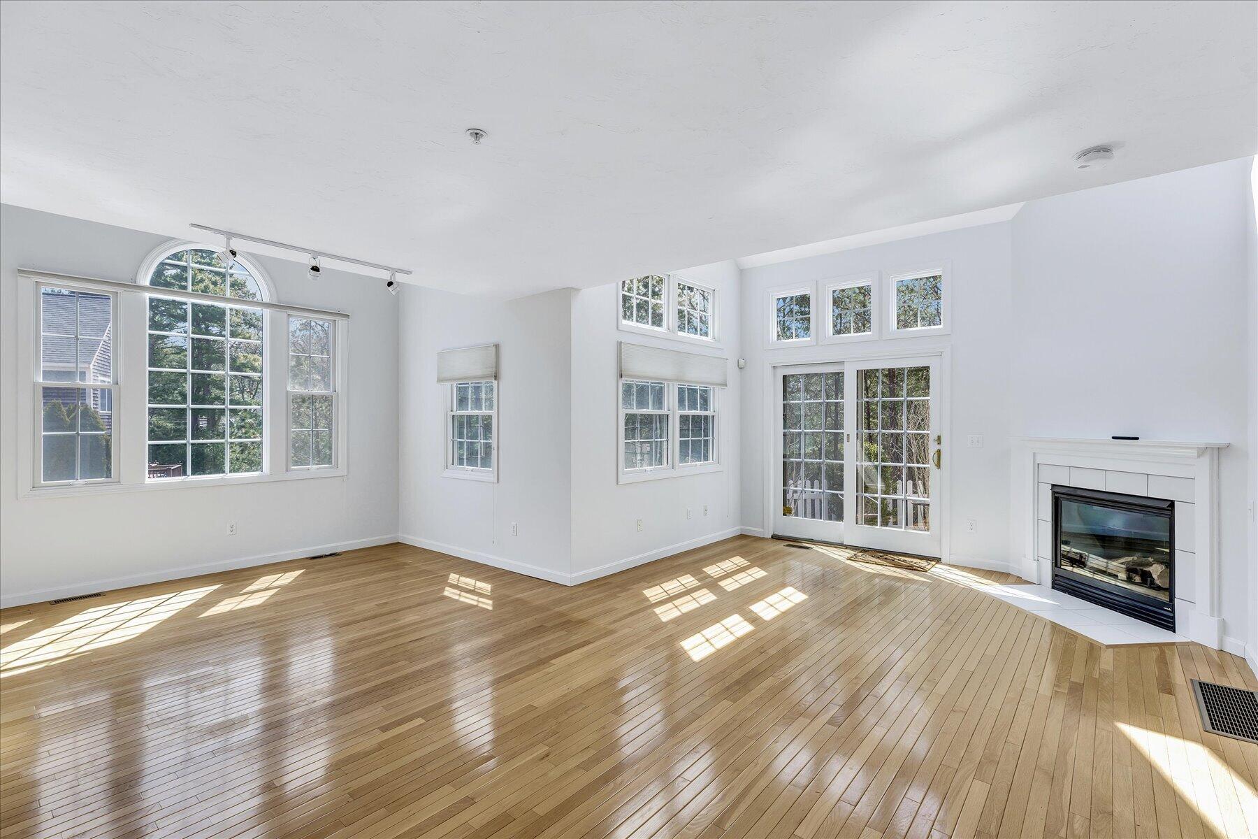 9 Red Cedar Road, Unit 9 Mashpee, MA 02649 - Photo 5 of 29 a view of an empty room with wooden floor and a window