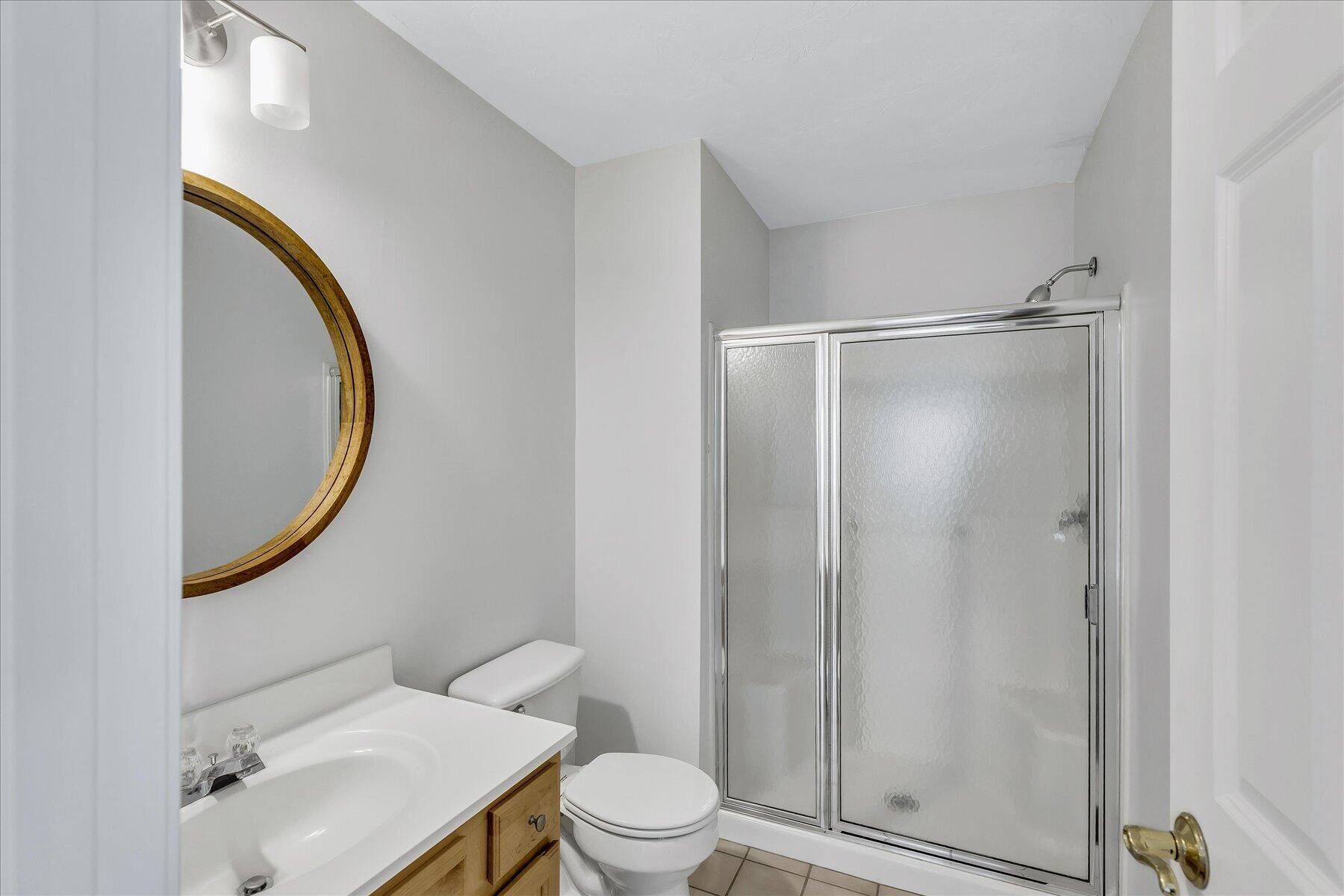 9 Red Cedar Road, Unit 9 Mashpee, MA 02649 - Photo 9 of 29 a bathroom with a granite countertop sink toilet and a mirror