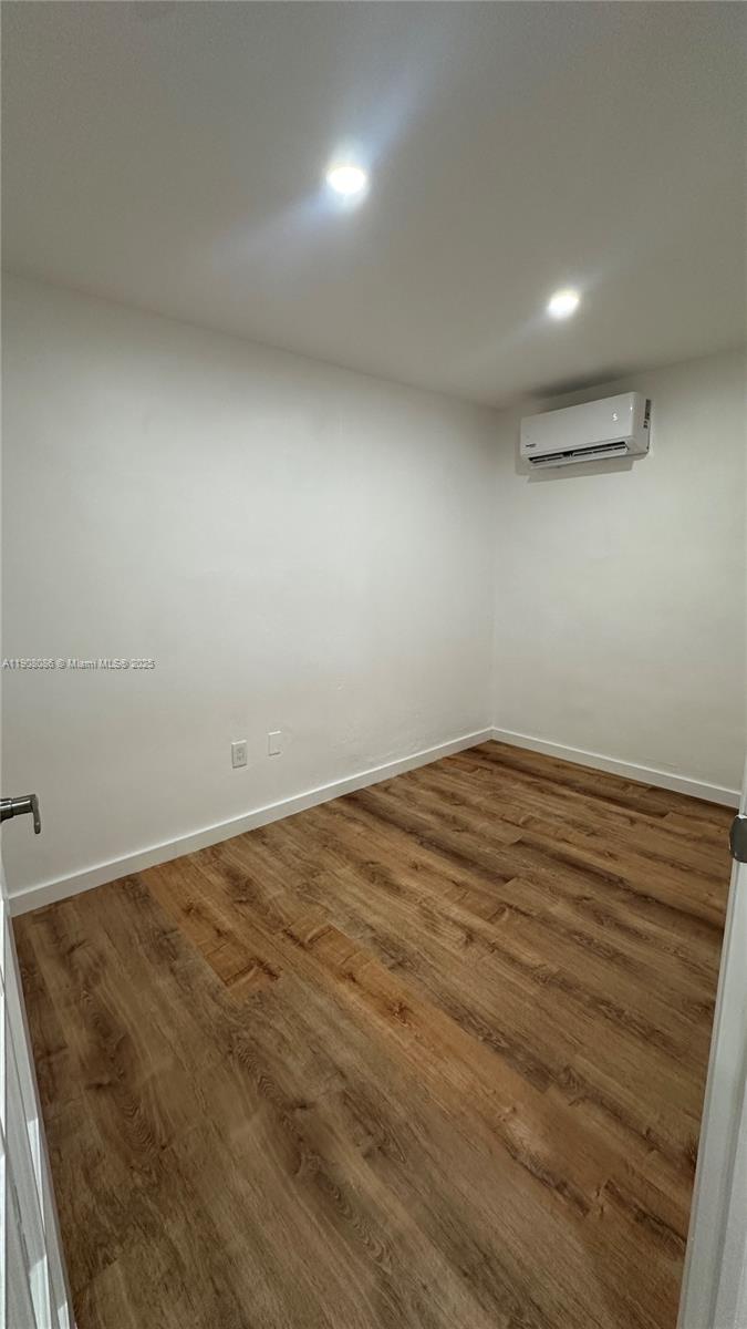 685 West 35th Street, Unit 685 Hialeah, FL 33012 - Photo 19 of 21 en empty room with wooden floor