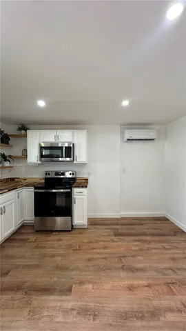 a kitchen with granite countertop a stove and cabinets