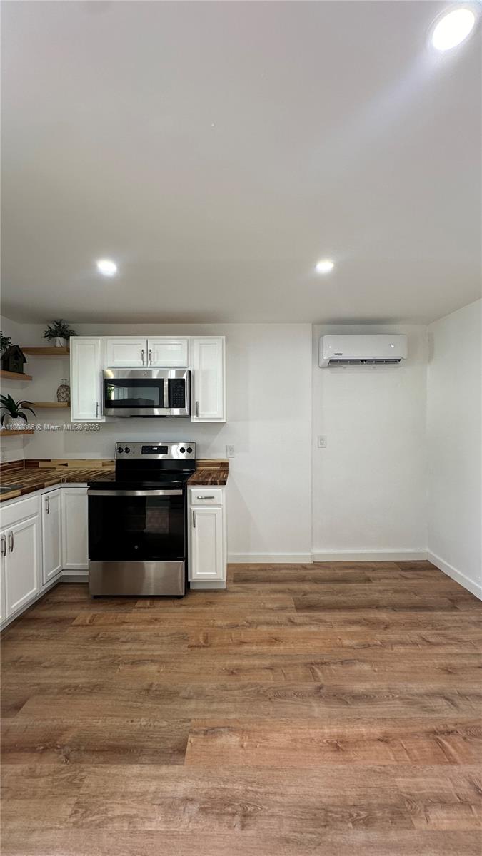 685 West 35th Street, Unit 685 Hialeah, FL 33012 - Photo 10 of 21 a kitchen with granite countertop a stove and cabinets