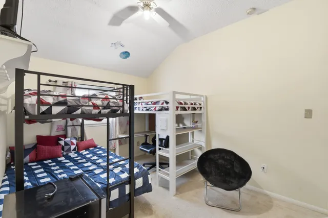 a kitchen with stainless steel appliances a dining table and chairs
