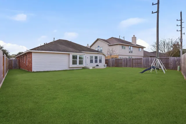 a view of a house with a backyard