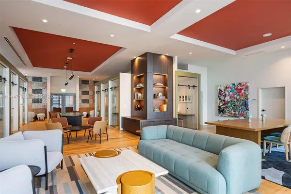 a living room with furniture kitchen and a table