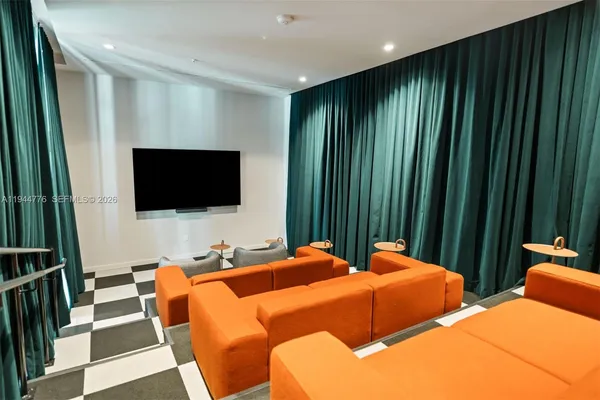 a bedroom with two beds and a flat screen tv