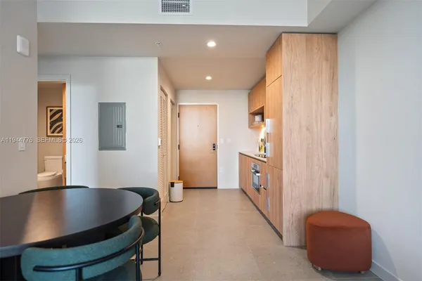 a hall with a cabinet and a granite counter top