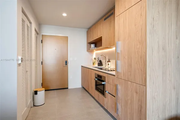 a view of kitchen with stainless steel appliances granite countertop a refrigerator and a sink
