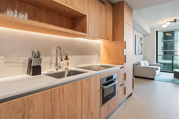 a kitchen with stainless steel appliances a sink and a refrigerator