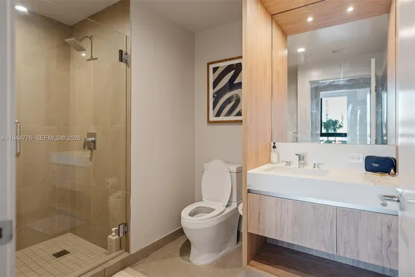 a bathroom with a toilet a sink and mirror