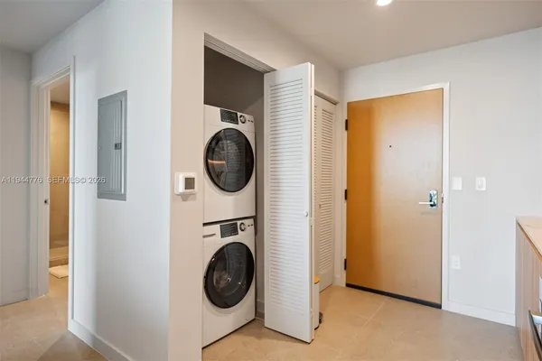 a view of a hallway with washer and dryer