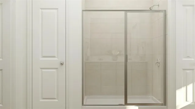 a large bed sitting in a bedroom next to a window