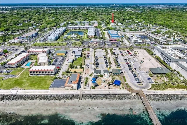an aerial view of a houses with a yard