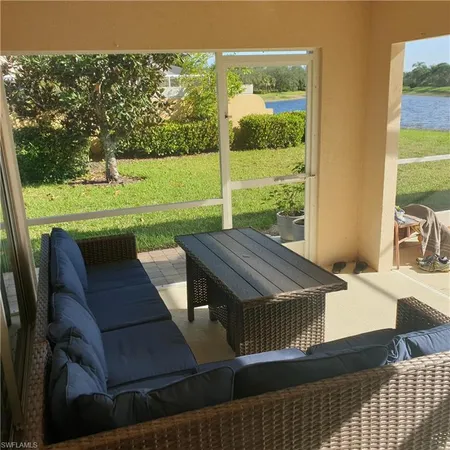 a view of a patio with table and chairs with wooden floor and fence