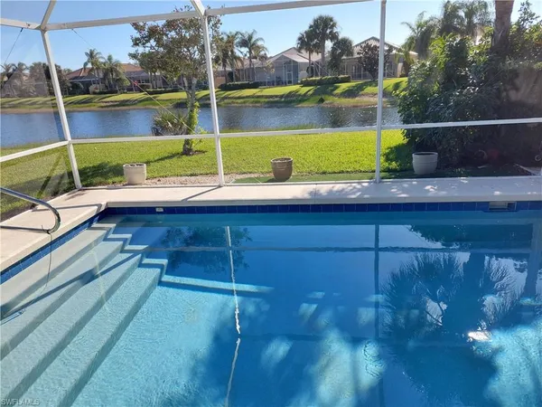a view of swimming pool with a lounge chairs