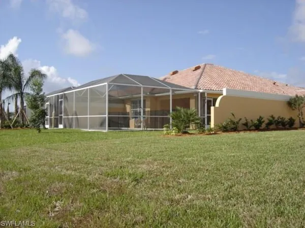 a view of a house with a backyard