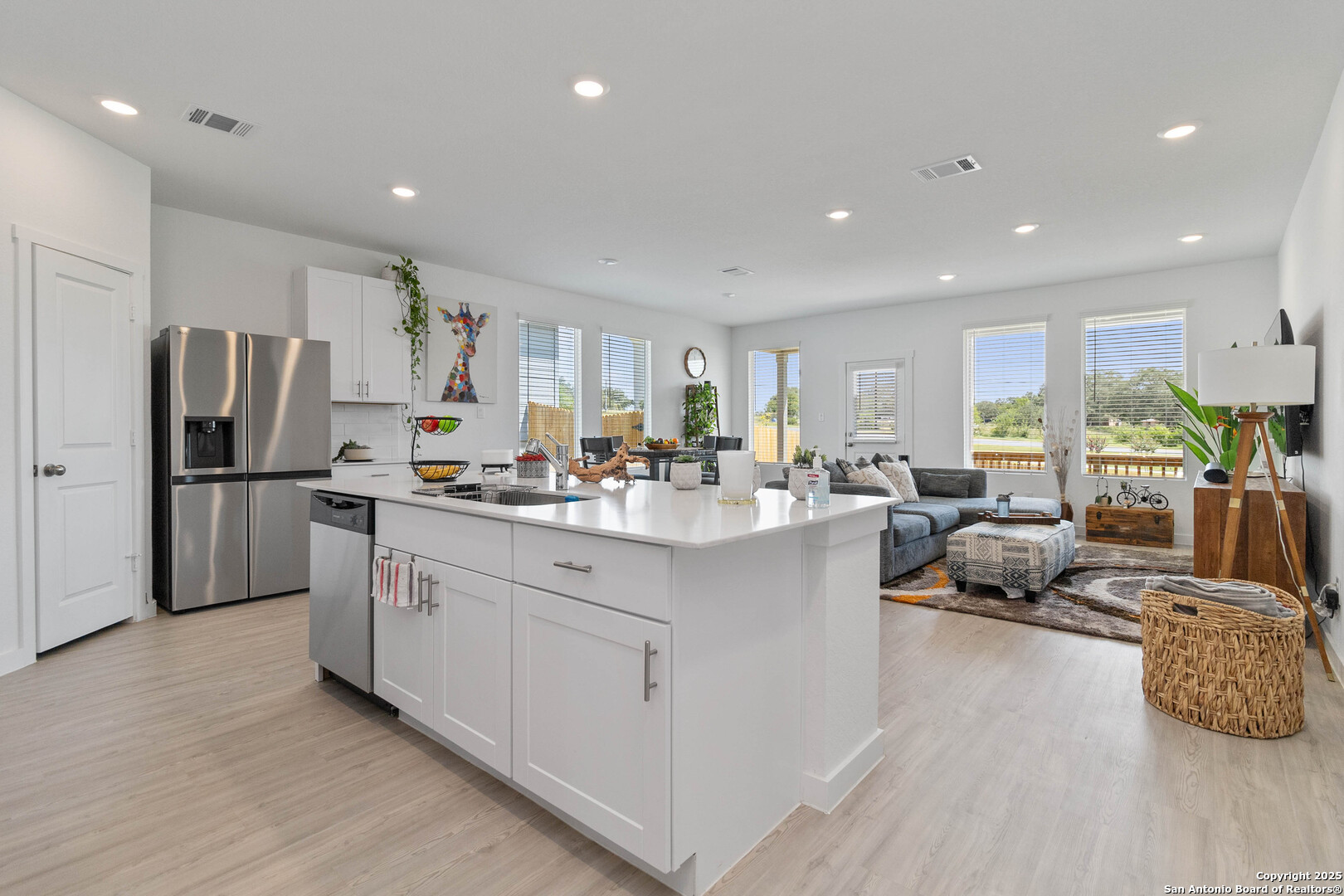 5708 Basil Chase St. Hedwig, TX 78152 - Photo 3 of 24 a kitchen with stainless steel appliances granite countertop a refrigerator sink and white cabinets
