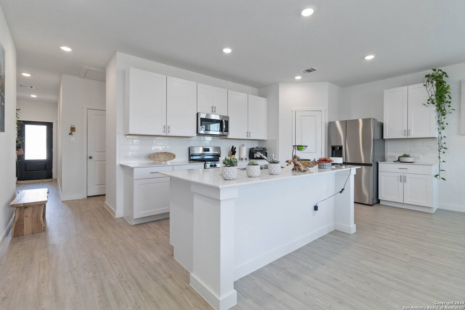 5708 Basil Chase St. Hedwig, TX 78152 - Photo 4 of 24 a kitchen with cabinets a sink and a refrigerator
