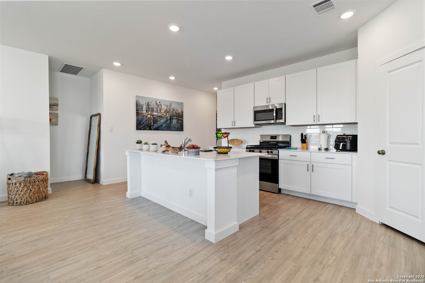 5708 Basil Chase St. Hedwig, TX 78152 - Photo 5 of 24 a kitchen with white cabinets and white appliances