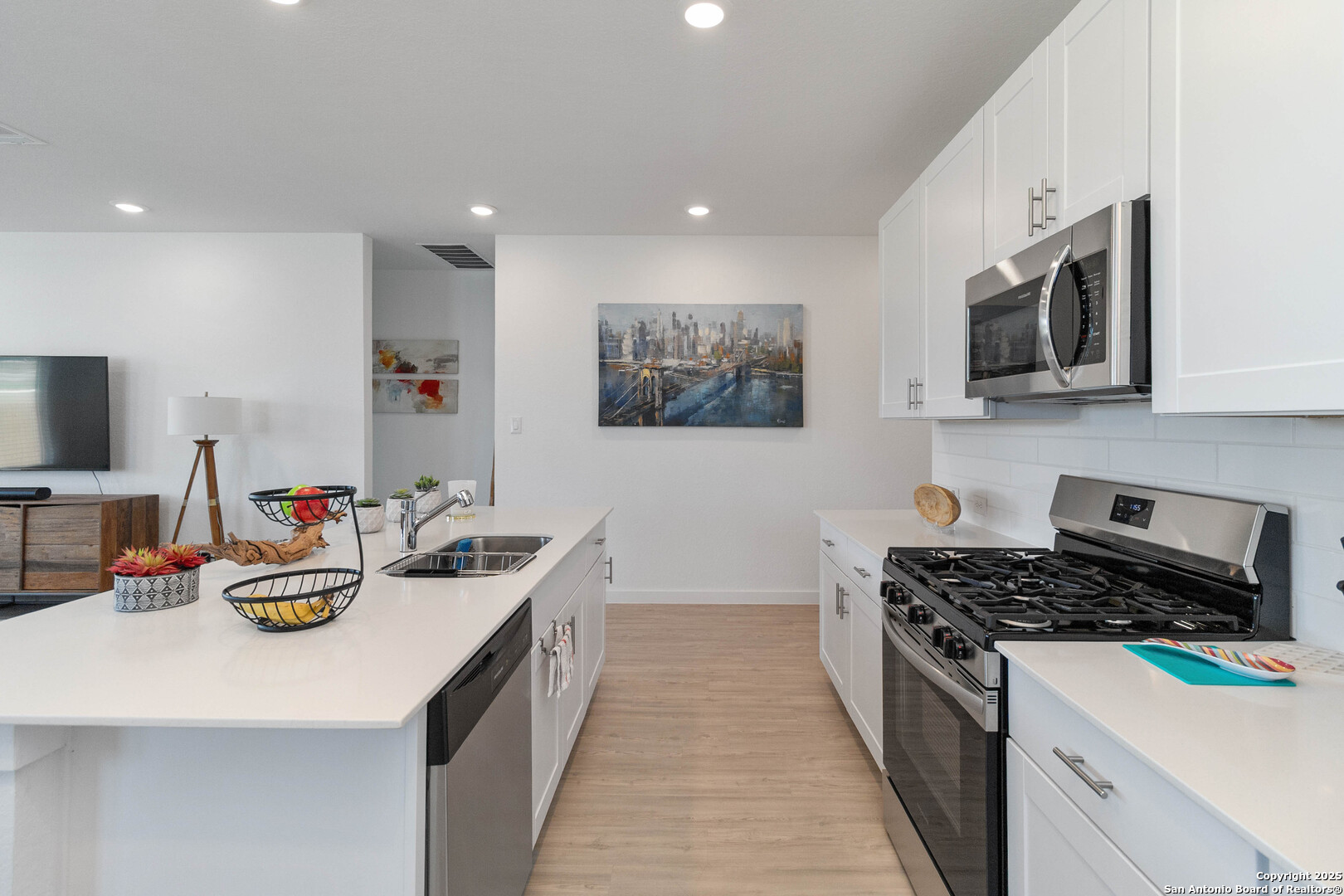 5708 Basil Chase St. Hedwig, TX 78152 - Photo 7 of 24 a kitchen with stainless steel appliances a stove a sink a microwave a refrigerator and cabinets