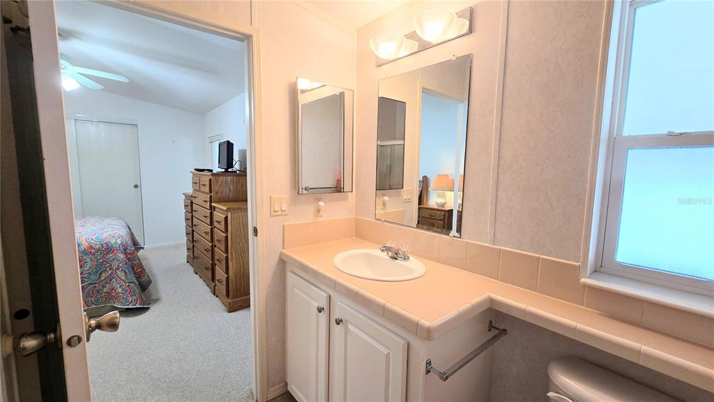 10303 Burnt Store Road, Unit 93 Punta Gorda, FL 33950 - Photo 22 of 65 a bathroom with a sink and a mirror