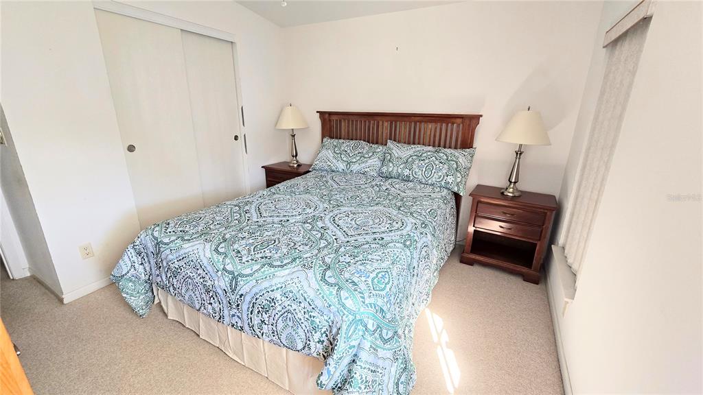 10303 Burnt Store Road, Unit 93 Punta Gorda, FL 33950 - Photo 24 of 65 a bedroom with a bed and a mirror