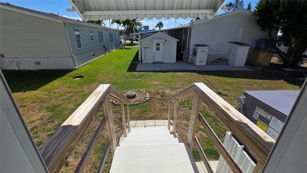 10303 Burnt Store Road, Unit 93 Punta Gorda, FL 33950 - Photo 28 of 65 a view of a backyard with sitting area