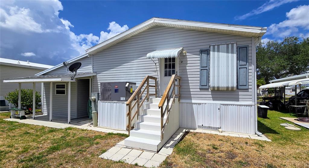 10303 Burnt Store Road, Unit 93 Punta Gorda, FL 33950 - Photo 30 of 65 a view of a house with backyard and porch