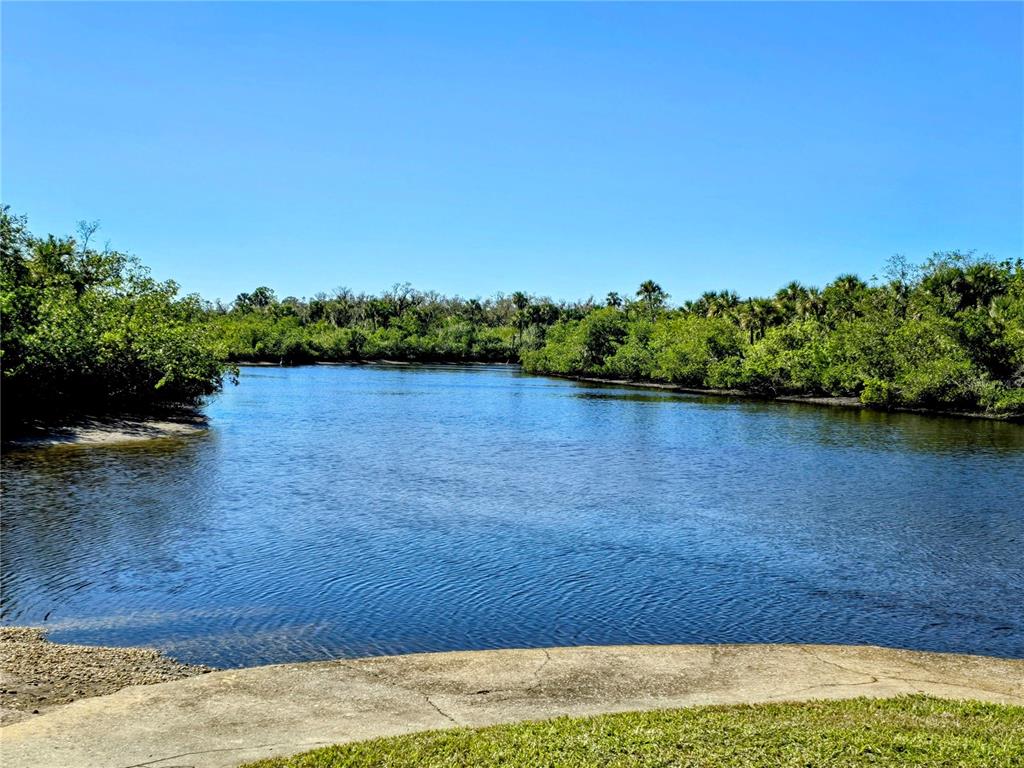 10303 Burnt Store Road, Unit 93 Punta Gorda, FL 33950 - Photo 4 of 65 a view of a lake from a yard