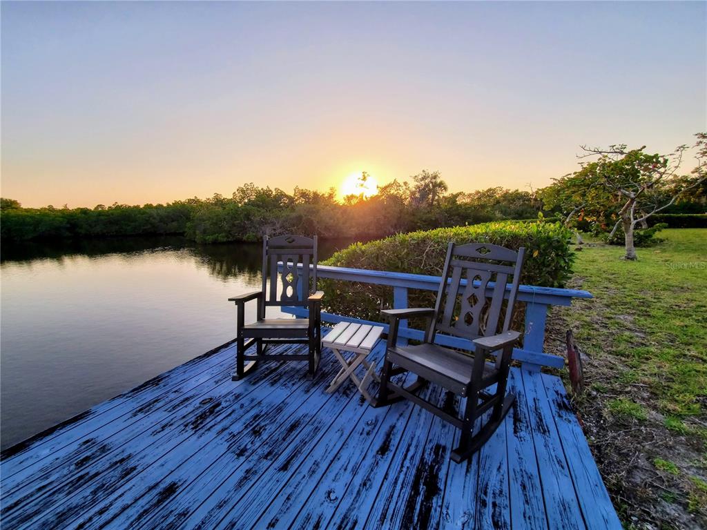 10303 Burnt Store Road, Unit 93 Punta Gorda, FL 33950 - Photo 47 of 65 a view of a lake with a table and chairs