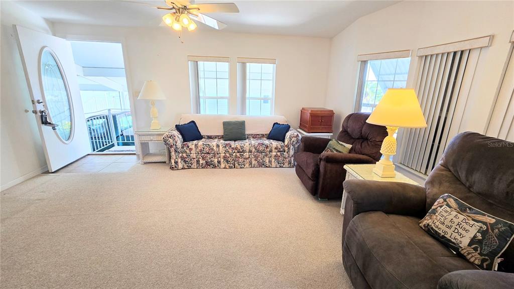 10303 Burnt Store Road, Unit 93 Punta Gorda, FL 33950 - Photo 5 of 65 a living room with furniture and a lamp
